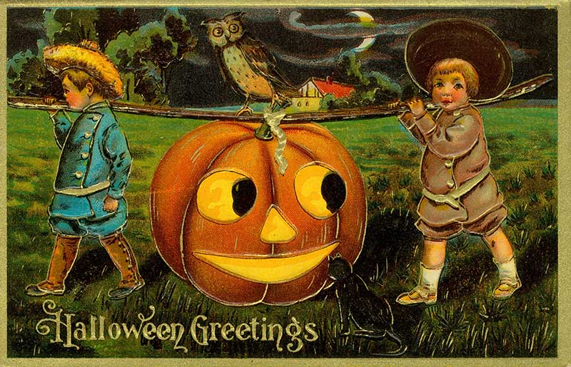 Two boys carrying a jack-o-lantern vintage postcard