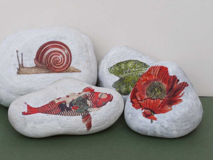 four rocks stones with printed vintage images on them